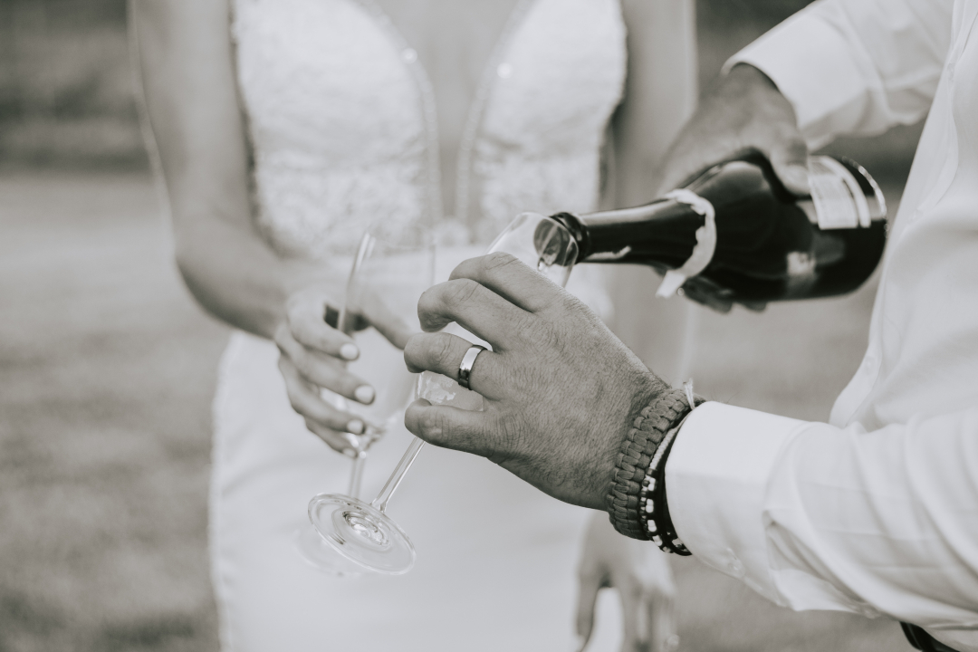 Bride and groom pouring champagne