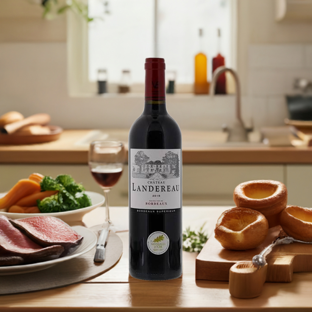 Bottle of Château Landereau Bordeaux Supérieur AC 2018 surrounded by food